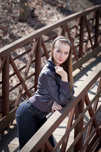 istock Young Female Fashion Model Posing on a forest bridge 485851271