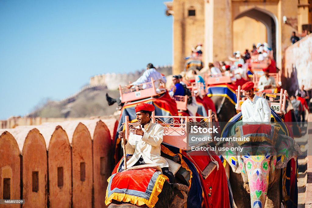 Elephant Riders Amber Fort Jaipur Jaipur, India - March 15, 2014: Elephant rider on his way down from Amber Fort to fetch more visitors to get the top of the Fort where The Amber Palace is located. Amber Fort Stock Photo