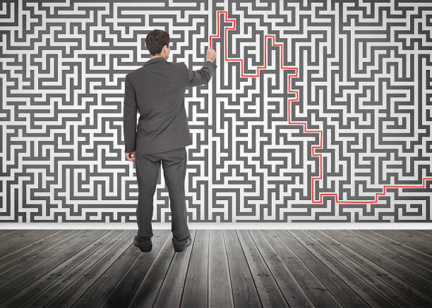 istock Businessman tracing red line on a maze 485851331
