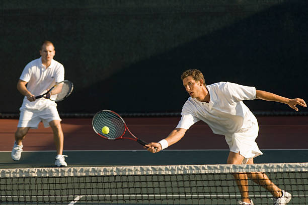 tennis-spieler schwingen am ball - doubles stock-fotos und bilder