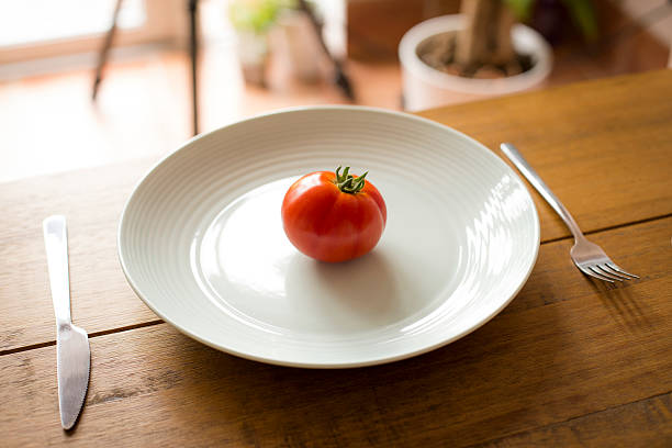 Single Tomato on a plate stock photo