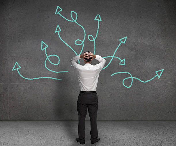 istock Stressed businessman looking at arrows 485854305