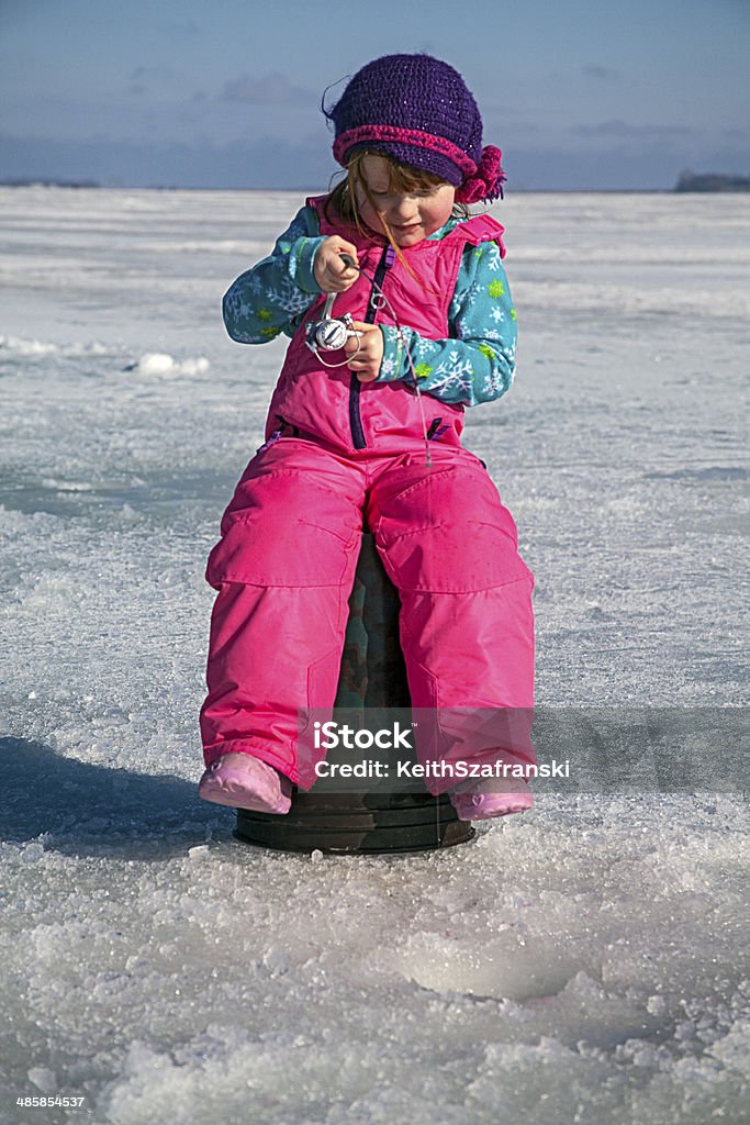 I Think I Caught One! Three year old girl ice fishing on Devil's Lake in North Dakota. Child Stock Photo