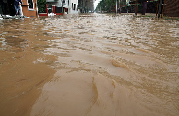 istock Road with the river mud overflown 485855829
