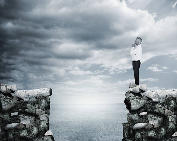 istock Businessman thinking at the edge of a cliff 485856275