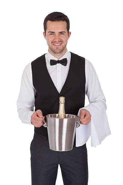 mayordomo alegre sosteniendo una botella de champán - waiter butler champagne tray fotografías e imágenes de stock