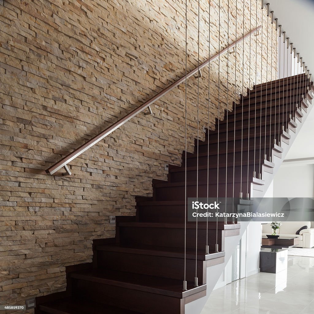 Brick wall and wooden stairs Brick wall and wooden stairs in designed interior 2015 Stock Photo