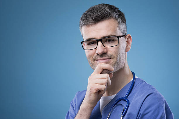 istock Smiling doctor with hand on chin 485859830
