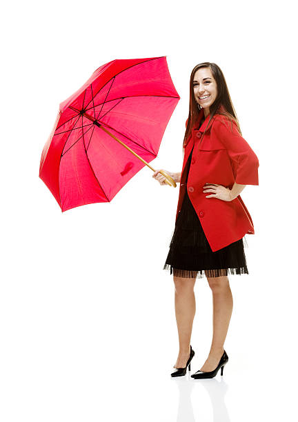 istock Happy young woman standing with umbrella 485862535