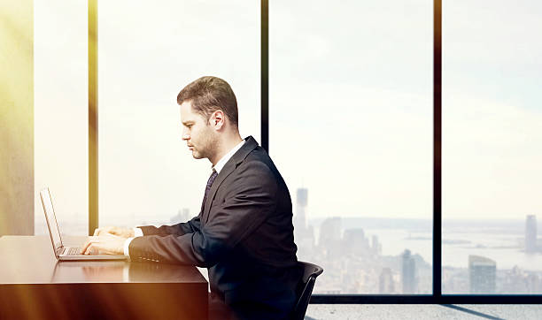 istock busienssman sitting in office with  laptop 485862912