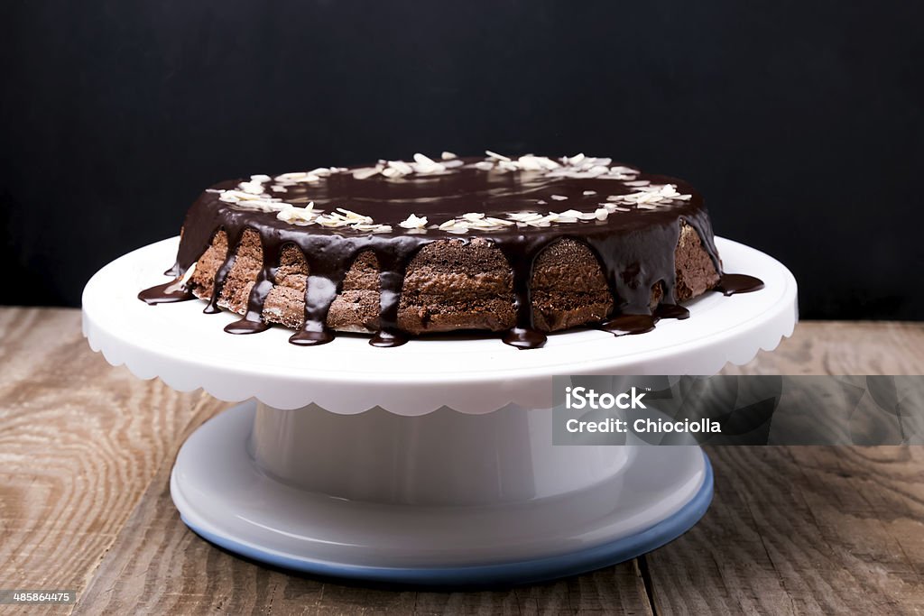 Chocolate cake Chocolate cake with chocolate frosting on white stand Almond Stock Photo