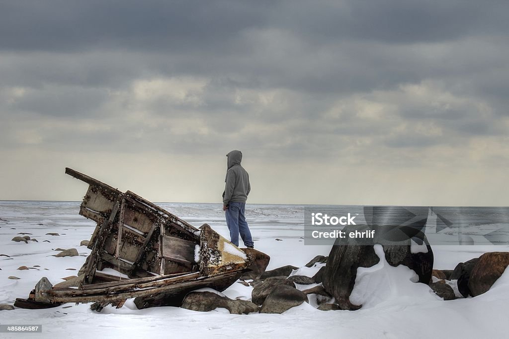 Shipwrecked Shipwrecked teenager on a barren winter shore. Stranded Stock Photo