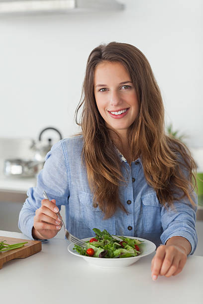 istock Woman eating a salad 485865669