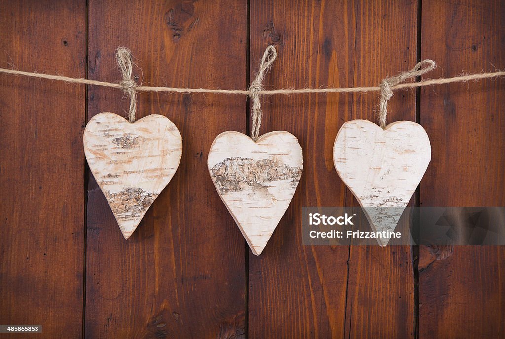 Three hanging wooden hearts. Three hanging wooden hearts - greeting card Art Stock Photo