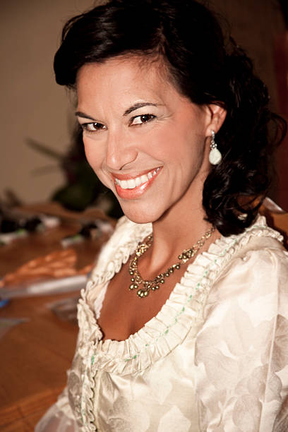istock Pretty Victorian-era dressed woman smiles for camera. 485865887