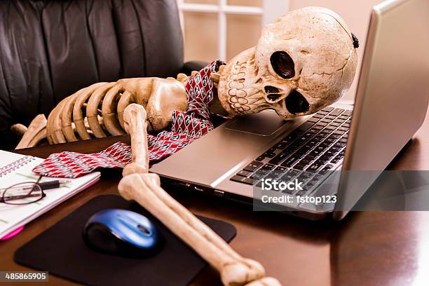 Working To Death Business Mans Skeleton Using Laptop In Office Stock Photo - Download Image Now