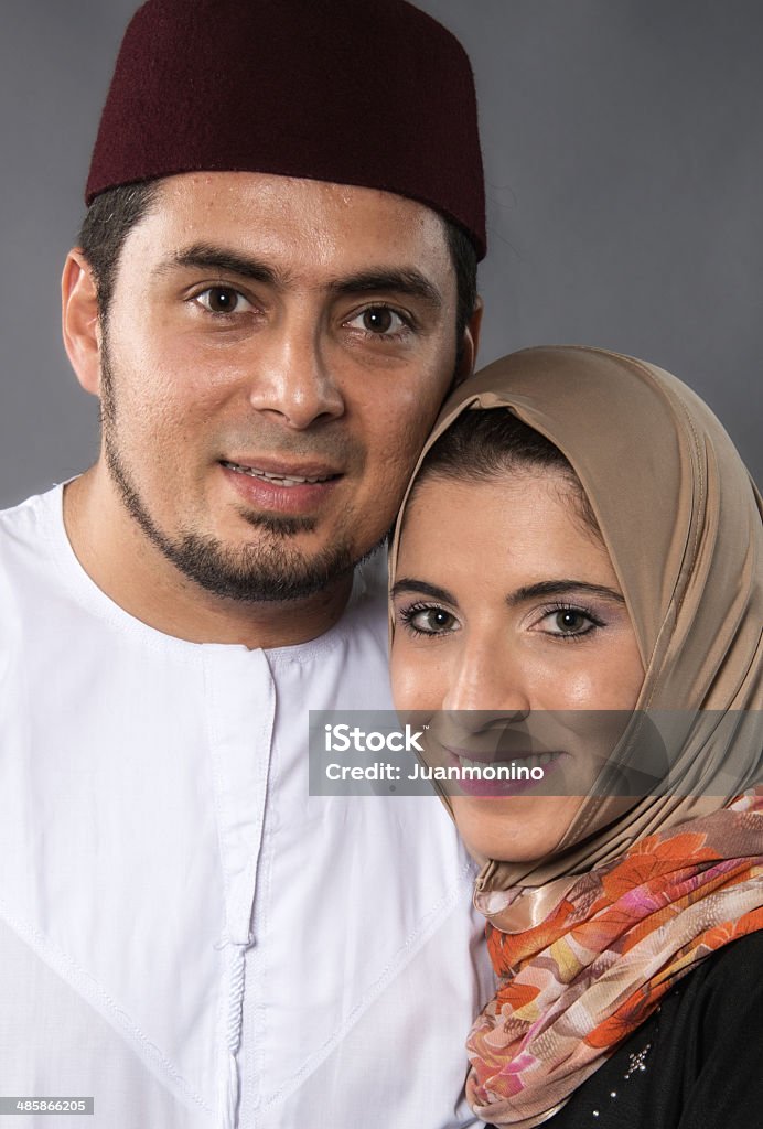 middle eastern couple Smiling middle eastern couple on gray background 30-39 Years Stock Photo