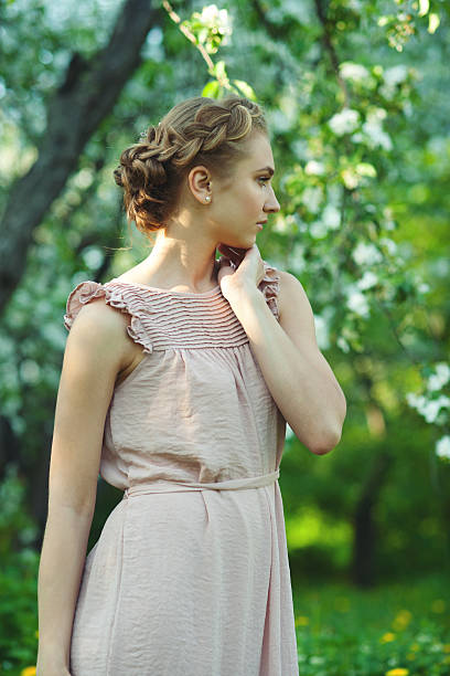Girl with beautiful updo hairstyle Portrait of girl with beautiful updo hairstyle with tress in summer garden, summertime braided buns stock pictures, royalty-free photos & images