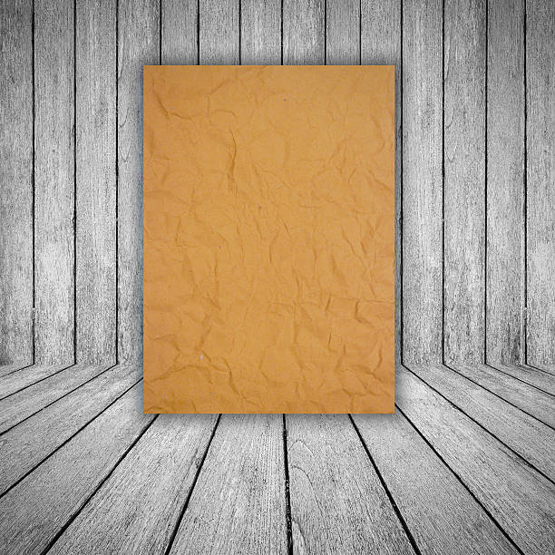 istock brown paper on wood background 485866585