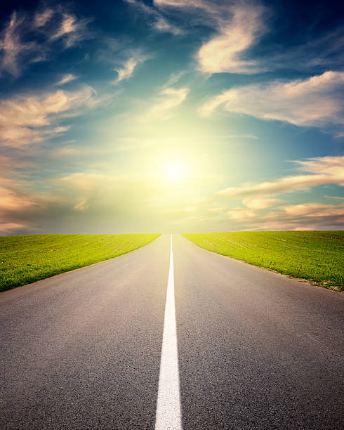 istock Driving on asphalt road towards the setting sun 485867369