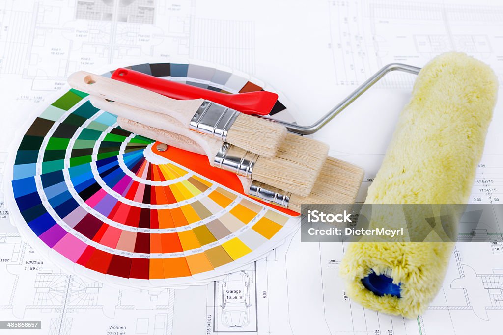 Color Swatch for home improvement blueprints and paintbrush Color Swatch for home improvement with blueprints of house plan and new paintbrush. Architecture Stock Photo