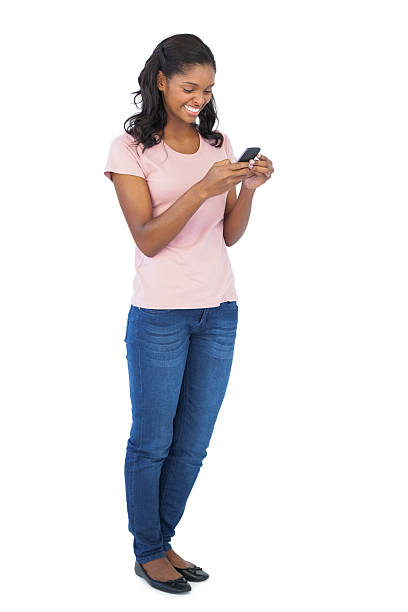 istock Young woman smiling and using mobile phone 485868717
