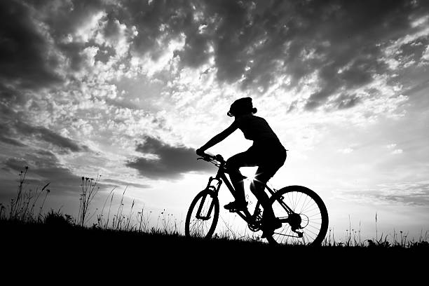 istock Biker-girl at the sunset on the meadow 485869546