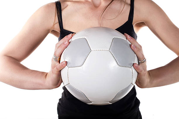 istock young woman holding a soccer ball 485869949