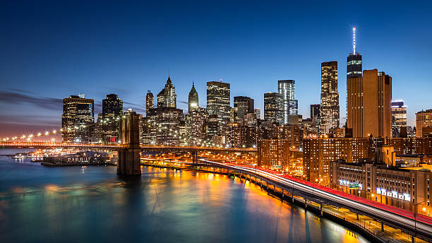 Brooklyn Bridge and Lower Manhattan Brooklyn Bridge and the New York Financial District at dusk east river new york city photos stock pictures, royalty-free photos & images