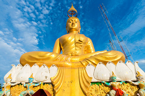 istock Big Golden Buddha statue against blue sky 485875918