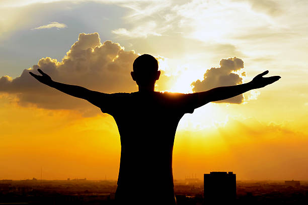 istock Silhouette of a man raising his arms 485876136