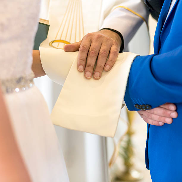 istock Wedding Ceremony With Hands Of Newlyweds And Priest 485876316