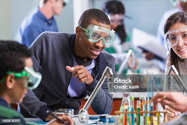 Multi Racial Students In Chemistry Class Wearing Safety Glasses Stock Photo - Download Image Now