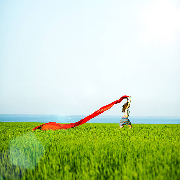 Jeune femme heureuse dans un champ de blé avec tissu.   Mode de vie de l'été - Photo