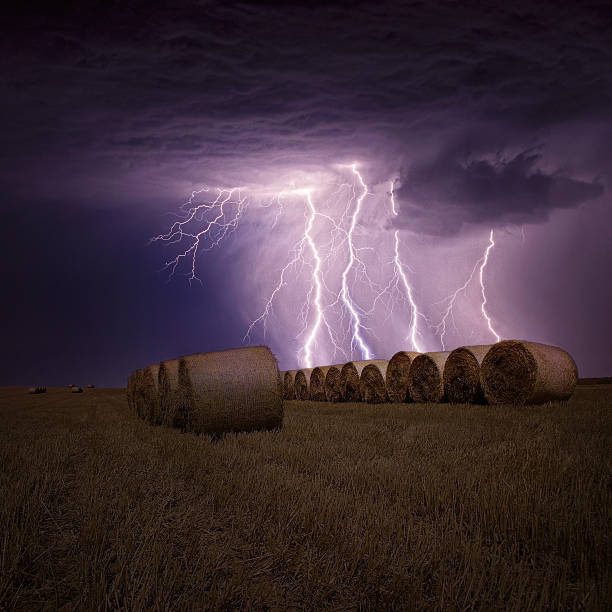 istock Summer meadow with bales and lightning strike 485881708
