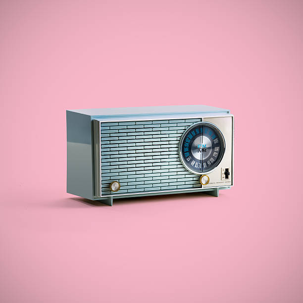 Close-up of vintage radio with rear panel removed, with vacuum tubes and speaker.