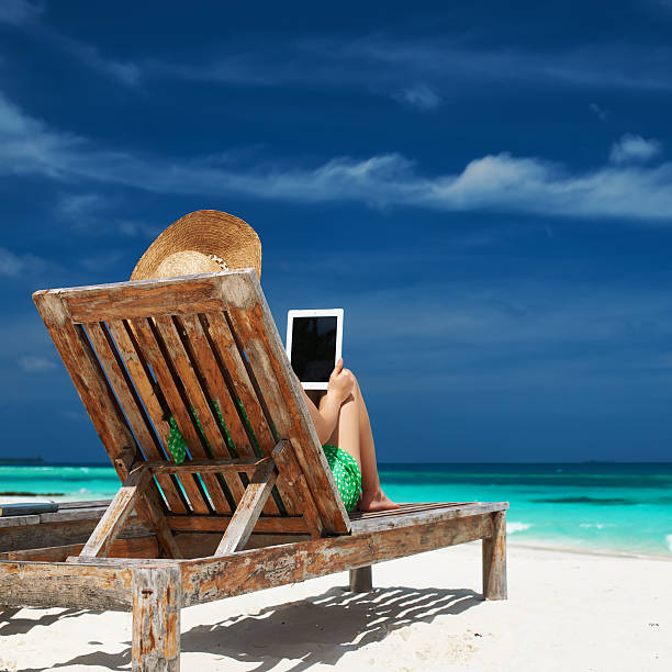 istock Young woman with tablet pc at the beach 485883139