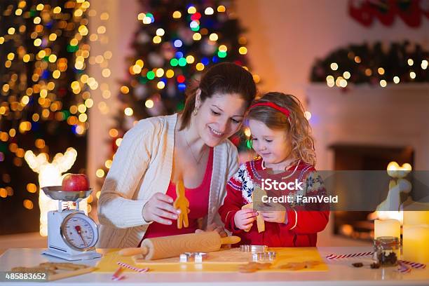 Mother And Daughter Baking Gingerbread For Christmas Dinner Stock Photo - Download Image Now