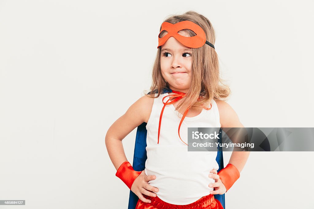 Kid portrait Funny little power super hero child (girl) in a blue raincoat. Superhero concept Baby - Human Age Stock Photo