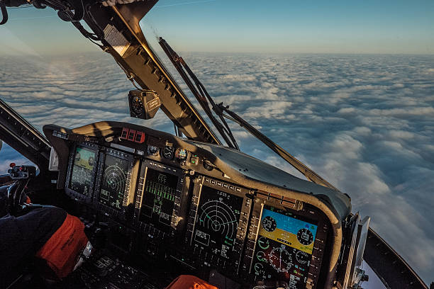 Helicopter Cockpit in flight Sikorsky S92 helicopter cockpit in flight above the clouds over the North Sea cockpit stock pictures, royalty-free photos & images