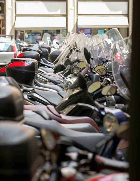 istock Motorbikes and mopeds parked in a line in a street. 485884586