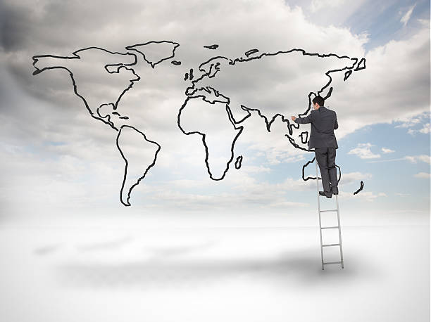 istock Businessman on ladder drawing a world map 485885637