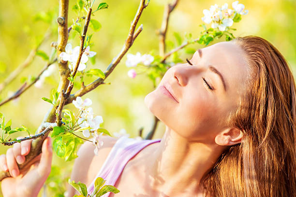 Relaxation in nature, barefoot girl lying down on the grass, enjoying spring.