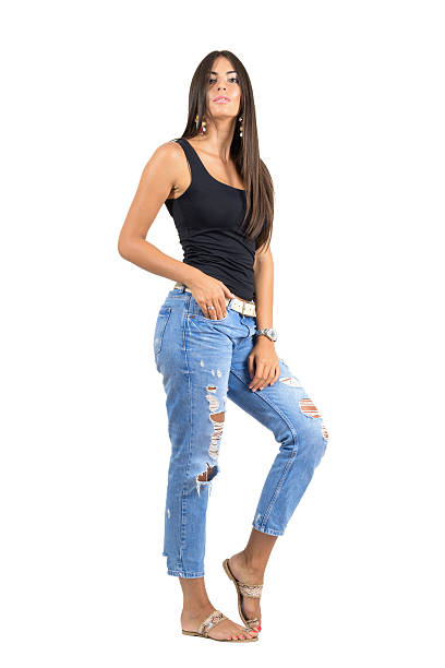istock Young casual woman in torn jeans posing at camera. 485887350