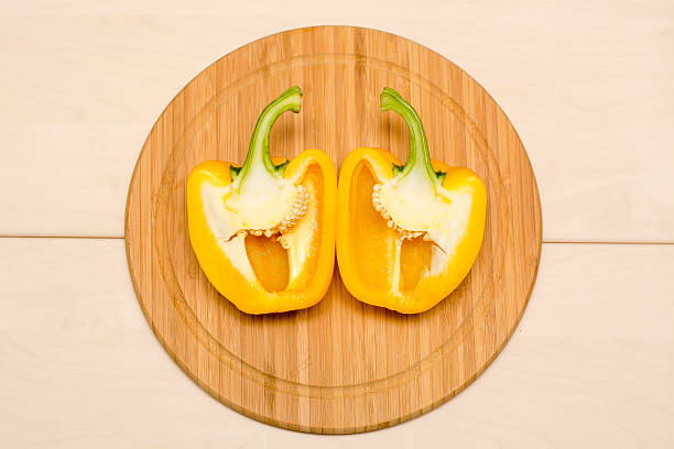 Yellow bellpepper in two halves stock photo