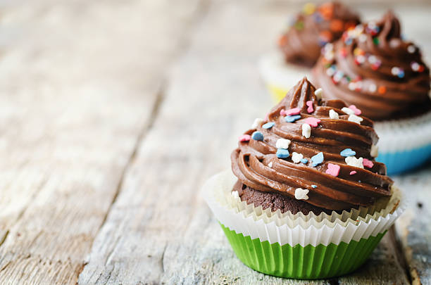 istock chocolate cupcakes with colorful sprinkles 485890324