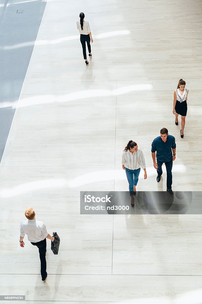 Young business people before starting work Young business people before starting work in their office High Angle View Stock Photo