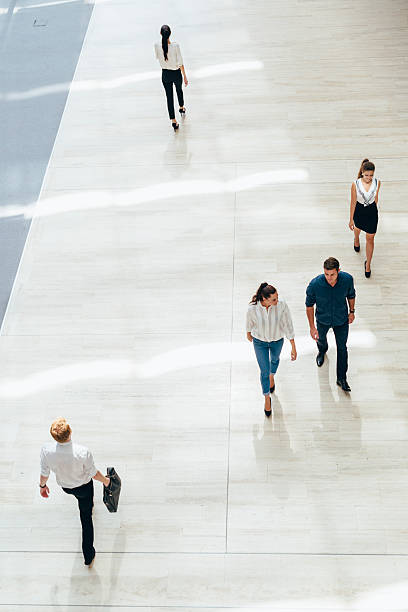 Young business people before starting work Young business people before starting work in their office mall walker stock pictures, royalty-free photos & images