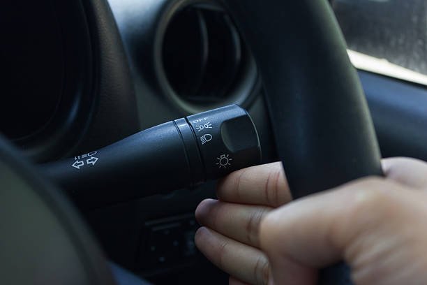 istock man hand use the signal switch. Car interior detail. 485894790
