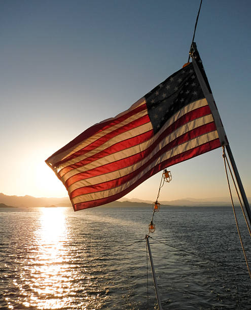 American Flag at Full Stretch at Sunset stock photo